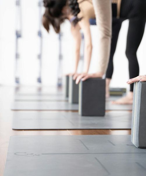 Minimalist yoga kit with mat and blocks in dark aesthetic